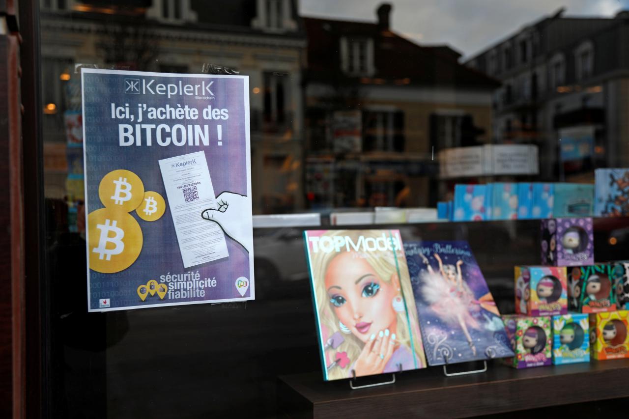 A placard of French startup Keplerk, for clients to purhcase bitcoins, is seen inside a tobacco shop at Rueil-Malmaison